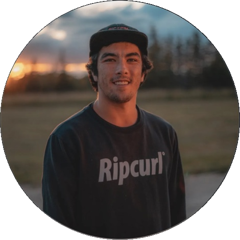 Daniel Grant in a Rip Curl cap and top at sunset