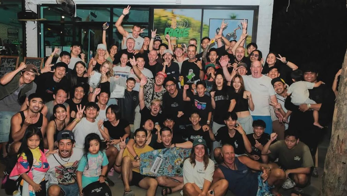 The TAO crew: a big group of riders, friends and kids cheering outside Cafe Tao at night